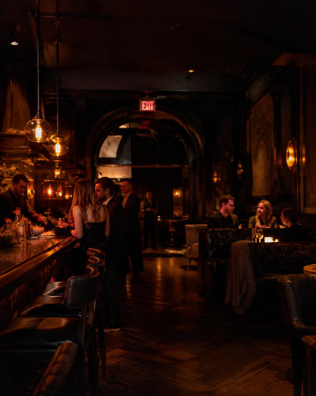 Dim speakeasy bar with leather booths